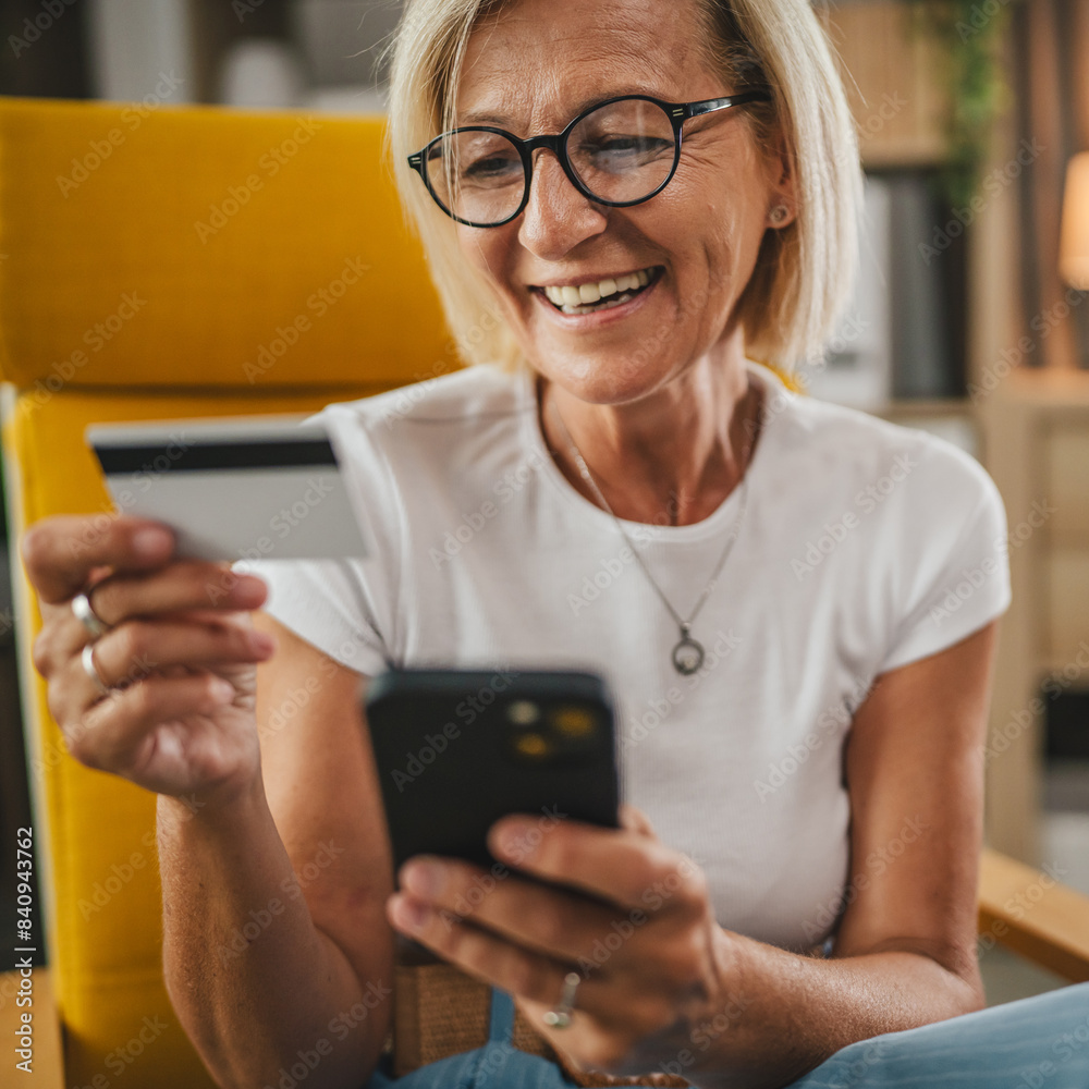 Mature senior woman buy online with credit card and on mobile phone at home Mature senior woman buy online with credit card and on mobile phone at home