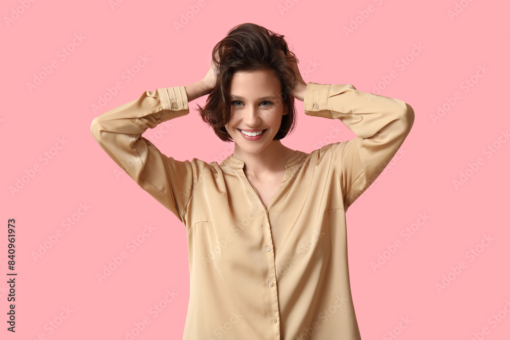 Beautiful young happy woman with bob hairstyle on pink background