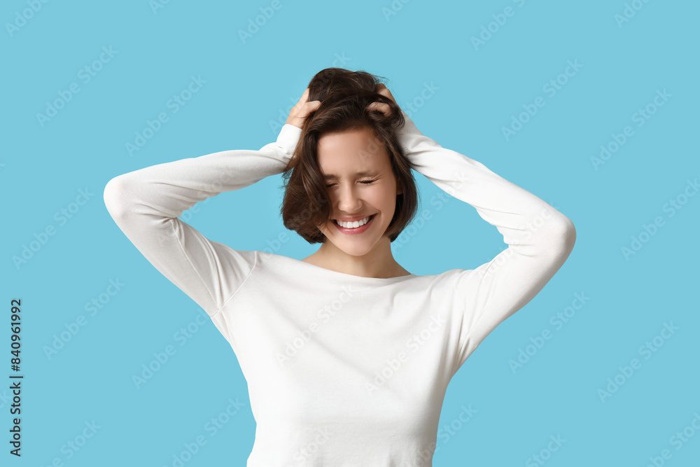 Beautiful young happy woman with bob hairstyle on blue background Beautiful young happy woman with bob hairstyle on blue background