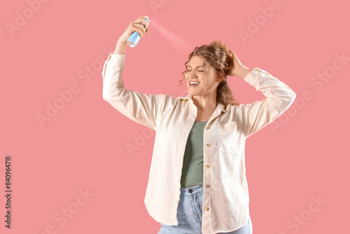Happy young woman applying ...