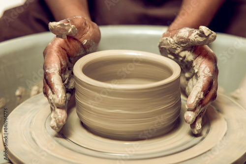 Sculptor working with a new product on a pottery wheel