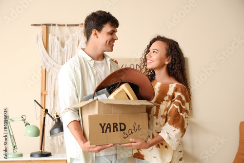 Young couple with box in ro...
