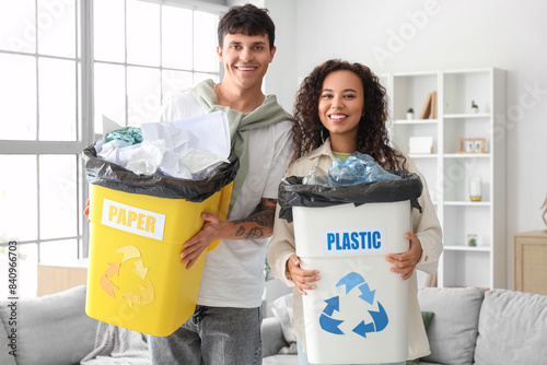 Young couple with garbage c...