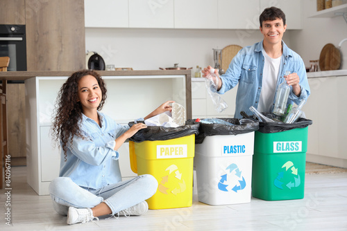 Young couple with garbage c...