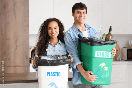 Young couple with garbage c...