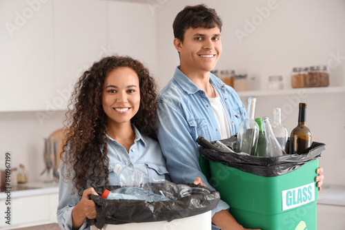 Young couple with garbage c...