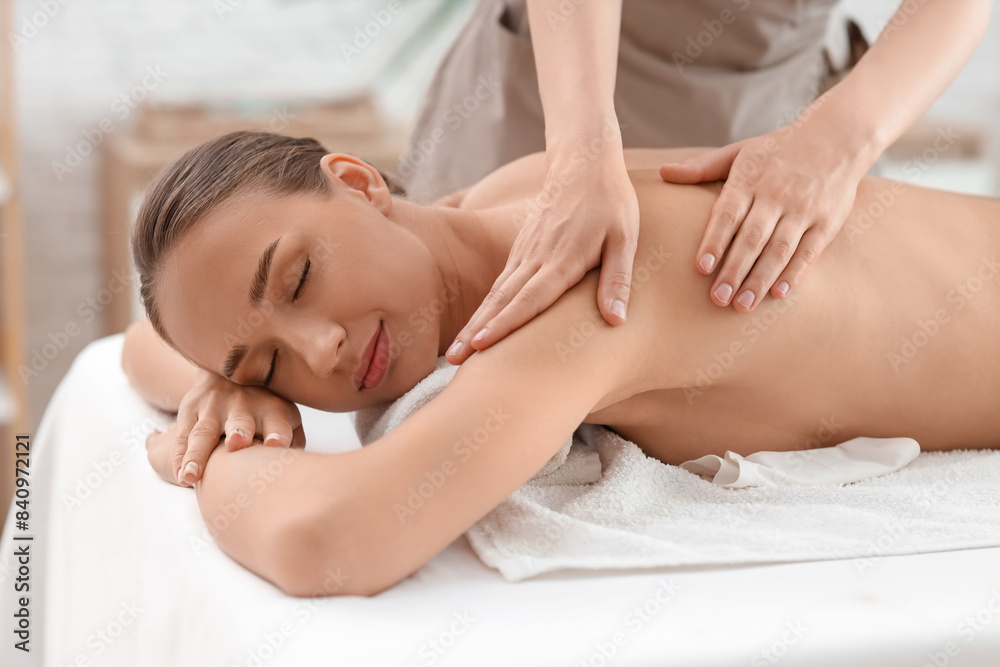 Beautiful young woman getting shoulder massage in spa salon, closeup Beautiful young woman getting shoulder massage in spa salon, closeup