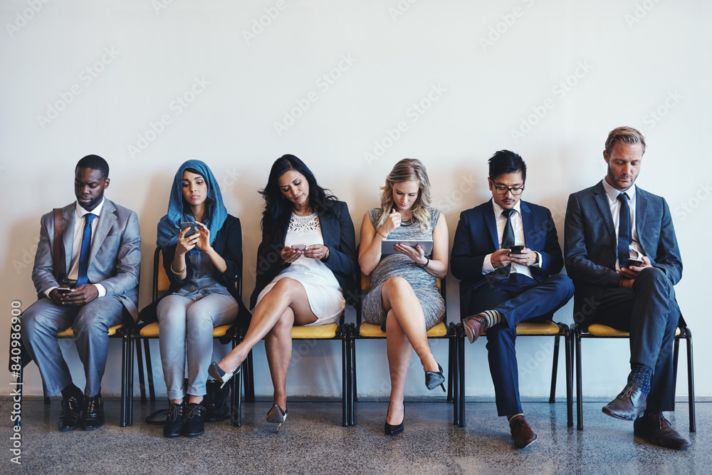 Obraz premium Technology, business people and waiting room for recruitment, interview or hr opportunity. Group, employees and row in office for hiring, human resources and corporate job search together for career