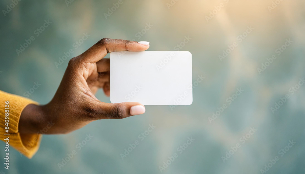 Woman's hand holding white business card, isolated on white background. Concept of professional networking and communication