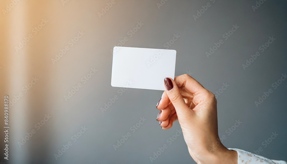 Woman's hand holding white business card, isolated on white background. Concept of professional networking and communication Woman's hand holding white business card, isolated on white background. Concept of professional networking and communication
