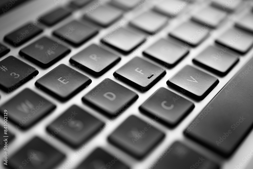 Detailed Close-Up View of a Modern Laptop Keyboard with Focus on the 'E' Key, Black and White Photography Detailed Close-Up View of a Modern Laptop Keyboard with Focus on the 'E' Key, Black and White Photography