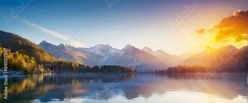 A beautiful lake surrounded by mountains with the sun rising over it.