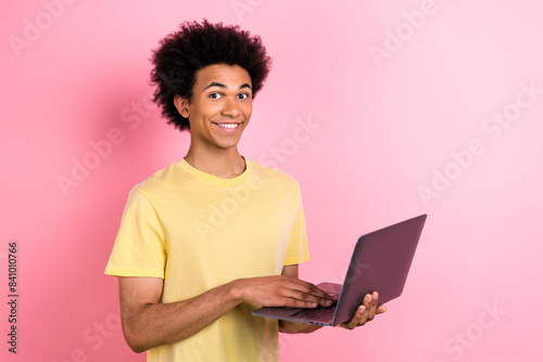 Portrait of positive person toothy smile hold use wireless netbook isolated on pink color background © deagreez