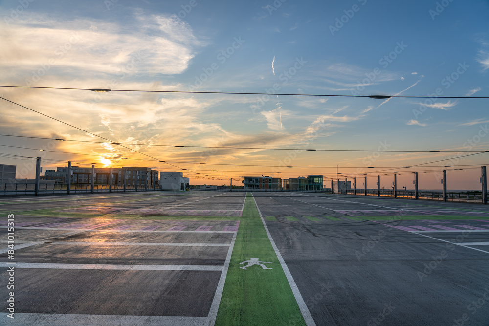 Fototapeta premium Empty rooftop carpark at sunset 
