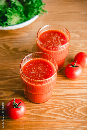 Two glasses of fresh tomato juice on a table