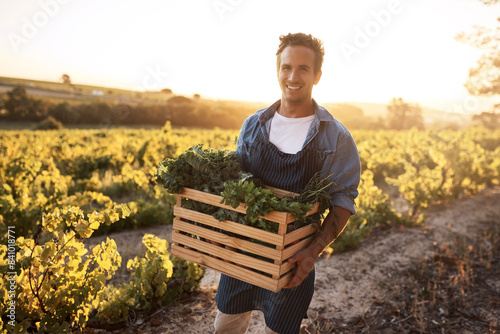Agriculture, box and portrait with farmer man outdoor for agribusiness, growth or sustainability. Flare, working and vegetables crate on harvest field of farm for ecology, grocery market or produce