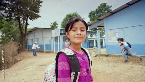 Portrait of a beautiful student girl in front of a public education building.