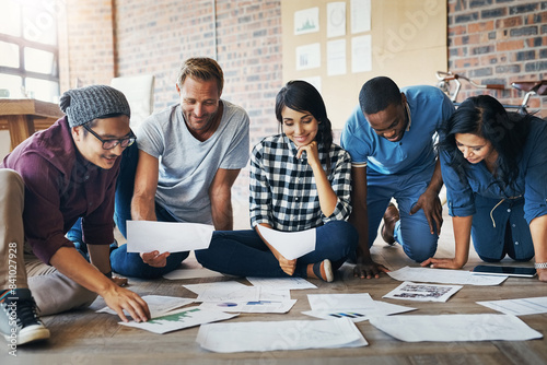 People, creative and happy in office with paperwork, collaboration and research for results. Nonprofit campaign, smile and ngo in workplace with donation or fundraising growth for community charity photo