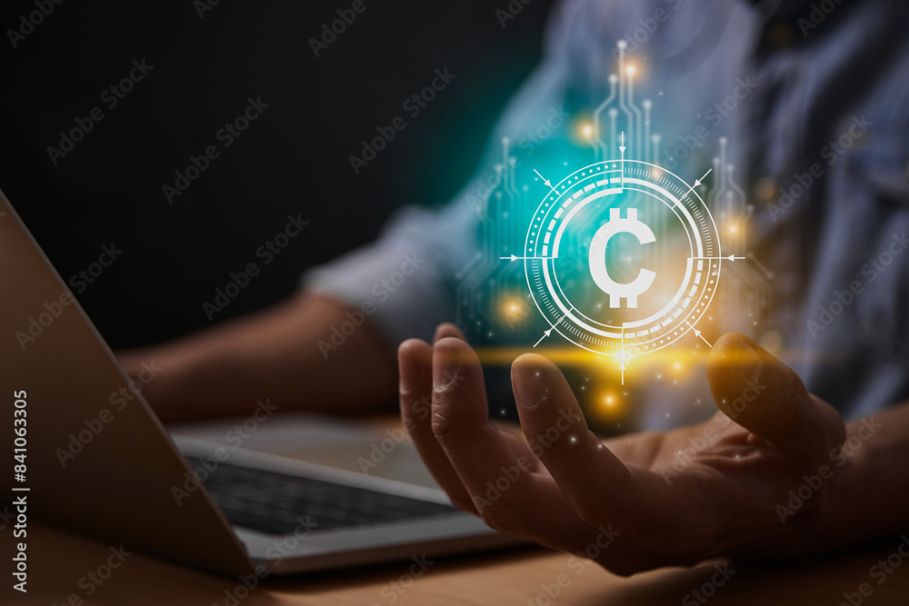 Turquoise Yellow Cryptocurrency or Coin Symbol Concept. Cryptocurrency Exchange Icon or Coin Symbol with Businessman's Hand and Laptop Computer Turquoise Yellow Cryptocurrency or Coin Symbol Concept. Cryptocurrency Exchange Icon or Coin Symbol with Businessman's Hand and Laptop Computer