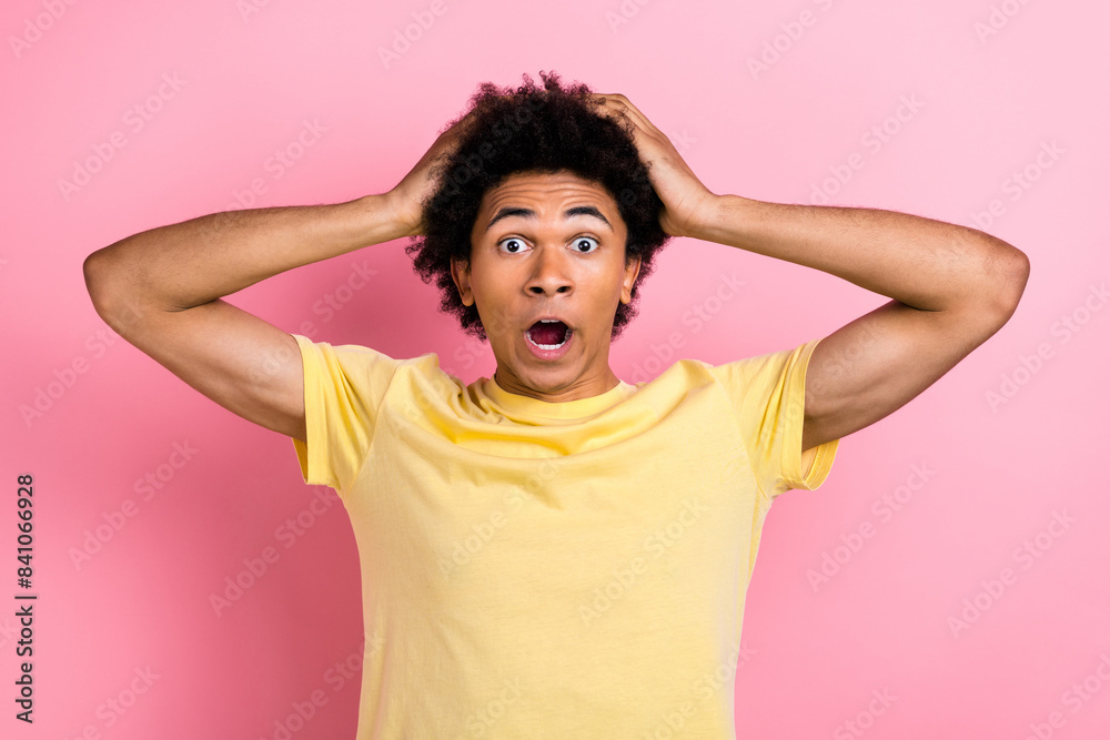 Photo of pretty impressed guy dressed yellow t-shirt open mouth arms head big eyes isolated pink color background Photo of pretty impressed guy dressed yellow t-shirt open mouth arms head big eyes isolated pink color background