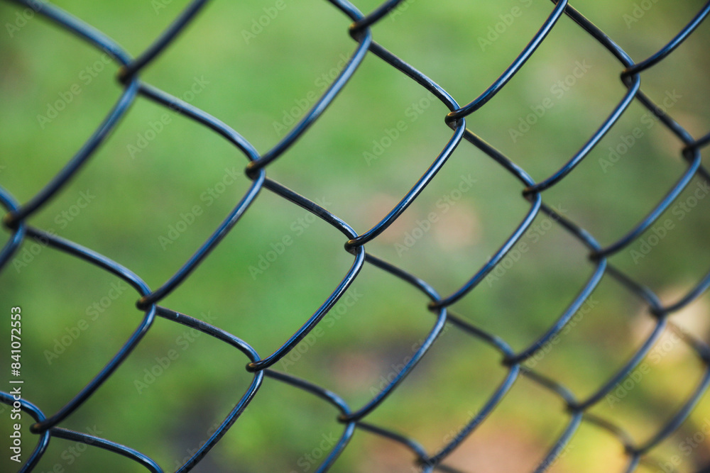 chain fence with blurred background, representing confinement and restriction chain fence with blurred background, representing confinement and restriction