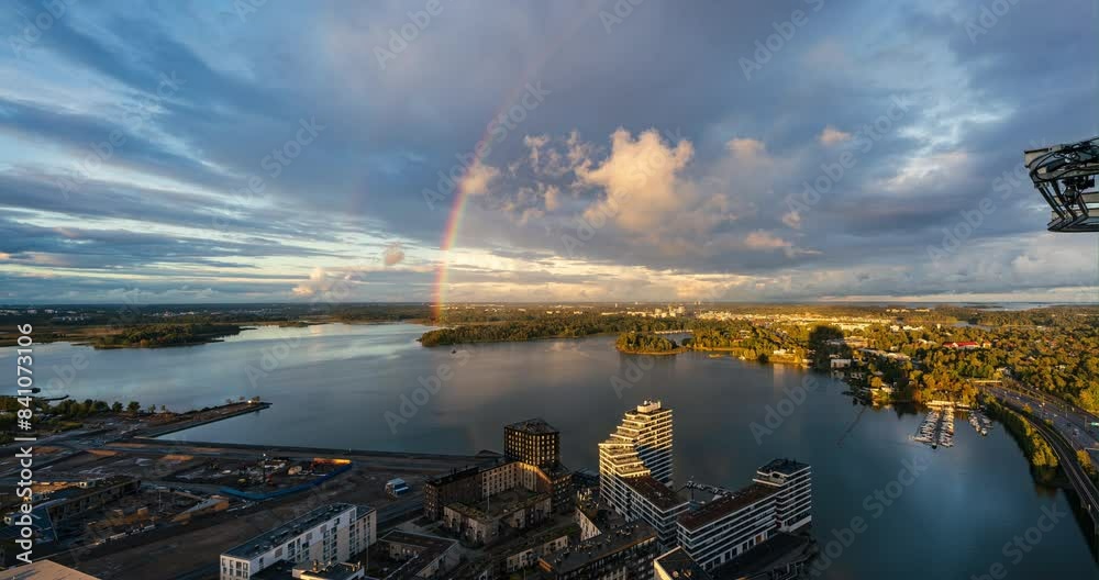 Time-lapse of a rainbow above the sea.', in front of the  Kulosaari, fall sunset in Helsinki