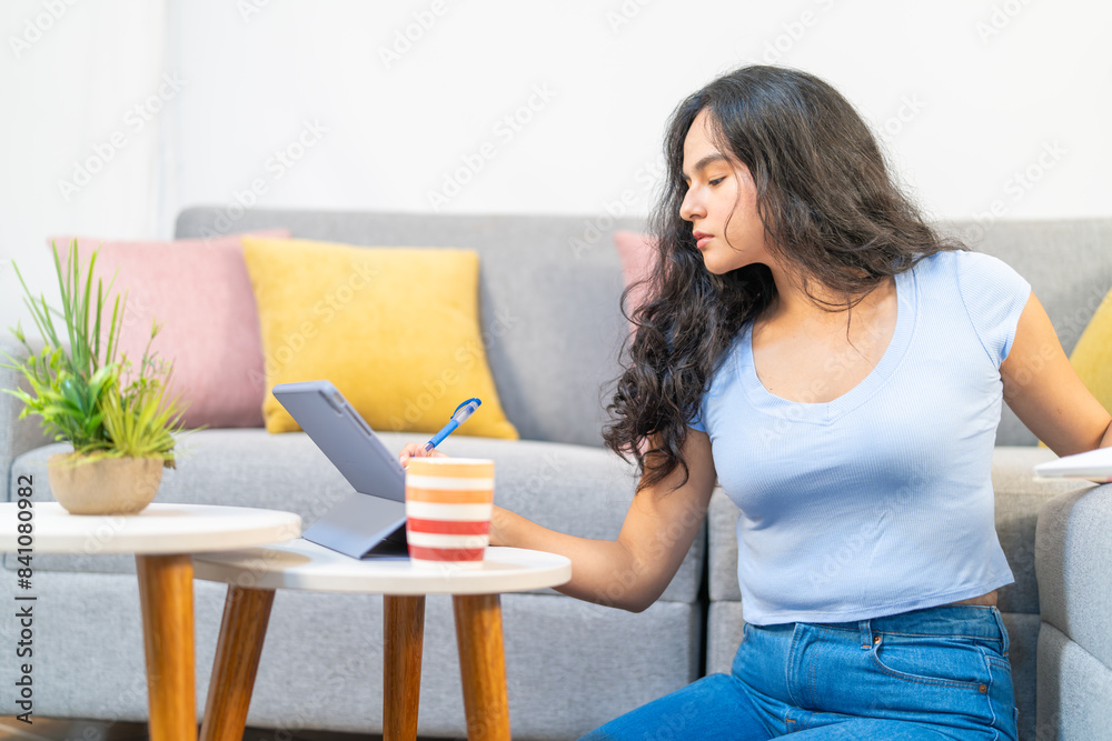 Young freelancer working from home using digital tablet Young freelancer working from home using digital tablet