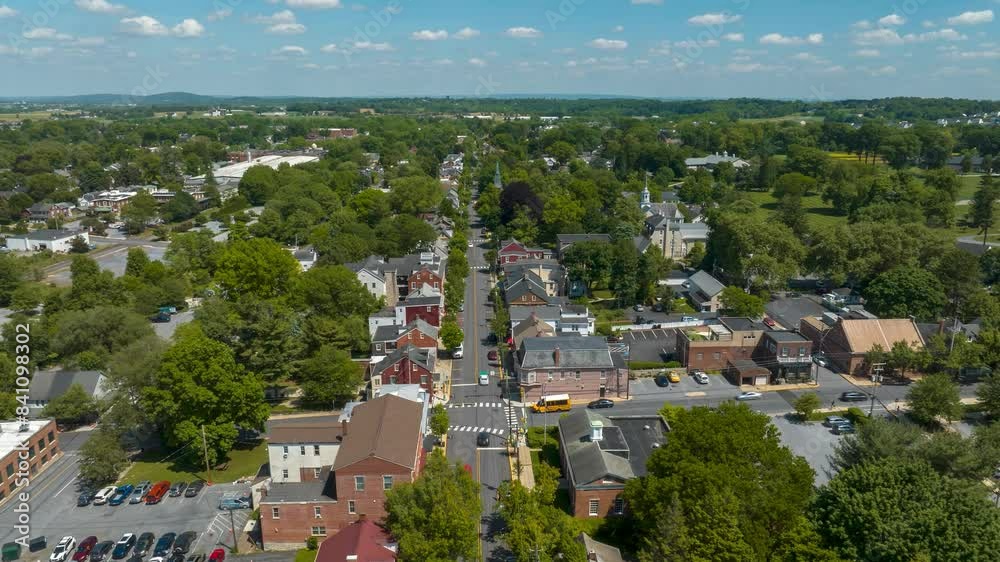 American town in summer. Aerial hyperlapse over busy downtown street with historic, quaint buildings, churches, and houses. Drone time lapse establishing shot. American town in summer. Aerial hyperlapse over busy downtown street with historic, quaint buildings, churches, and houses. Drone time lapse establishing shot.