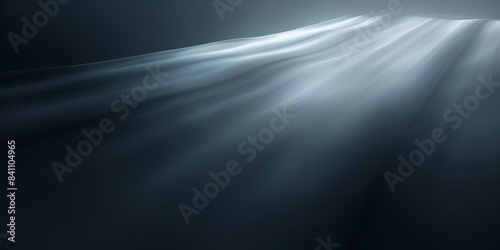a bright light beam that seems to be shining down or up, with a bokeh effect of dark shapes around it.