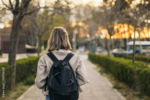 Back view portrait of a blonde student girl
