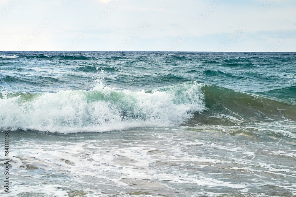 Waves on the sea on the background of the cloudy sky. Evening on vacation. Waves on the sea on the background of the cloudy sky. Evening on vacation.