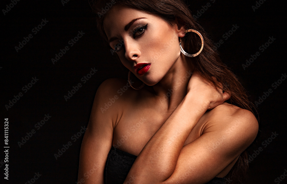 Beautiful elegant woman with perfect face and amazing natural gloss skin in fashion earrings in dark shadow black background. Closeup portrait Beautiful elegant woman with perfect face and amazing natural gloss skin in fashion earrings in dark shadow black background. Closeup portrait