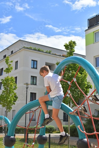 boy climbing ropes on a sports ground