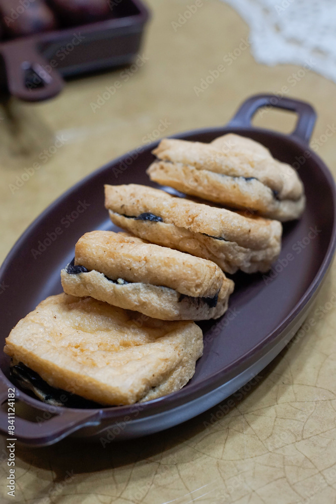 Tahu petis, fried tofu filled with black shrimp paste Tahu petis, fried tofu filled with black shrimp paste