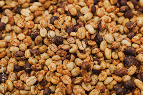 "Coffee beans sun-drying after having their pulp removed, before further processing using the honey process, also known as the red process or yellow process."