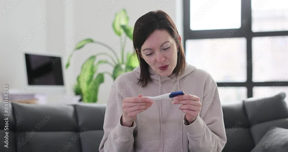 Enthusiastic young woman celebrating positive pregnancy test result at home Enthusiastic young woman celebrating positive pregnancy test result at home