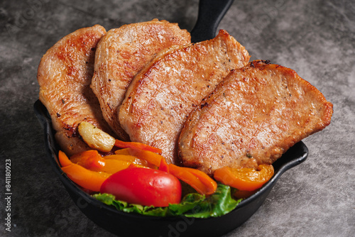 Close-up Pork Sirloin Steak with Fresh salad vegetables photo