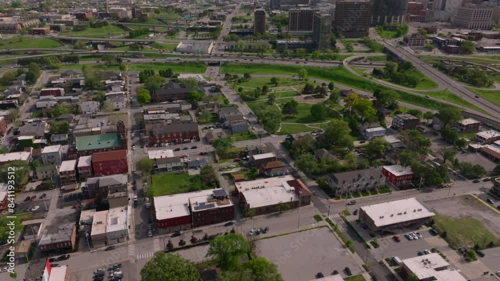 Overhead view of a lively cityscape with low buildings, parks, and streets, offering a detailed look at the urban design and structure Overhead view of a lively cityscape with low buildings, parks, and streets, offering a detailed look at the urban design and structure