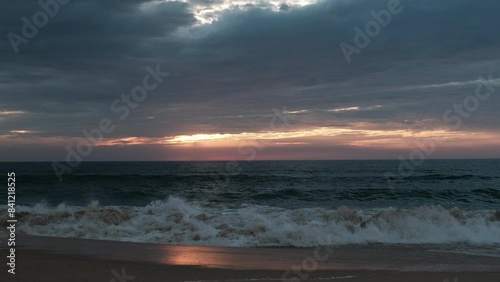 waves of the altlantic ocean crushing onto the beach at the cote de argent in France with golden sunset in the background, Cap Ferret, Aquitaine, France photo