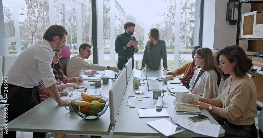 Mixed race team of businesspeople or workers engaging in a brainstorming session, exchanging ideas or strategizing for growth in a modern office environment. Mixed race team of businesspeople or workers engaging in a brainstorming session, exchanging ideas or strategizing for growth in a modern office environment.
