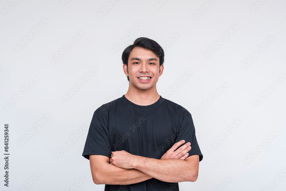Fototapeta premium Confident asian man in black t-shirt smiling isolated on white