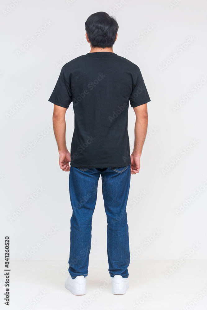 Obraz premium Handsome Asian man in black T-shirt standing, isolated on white background