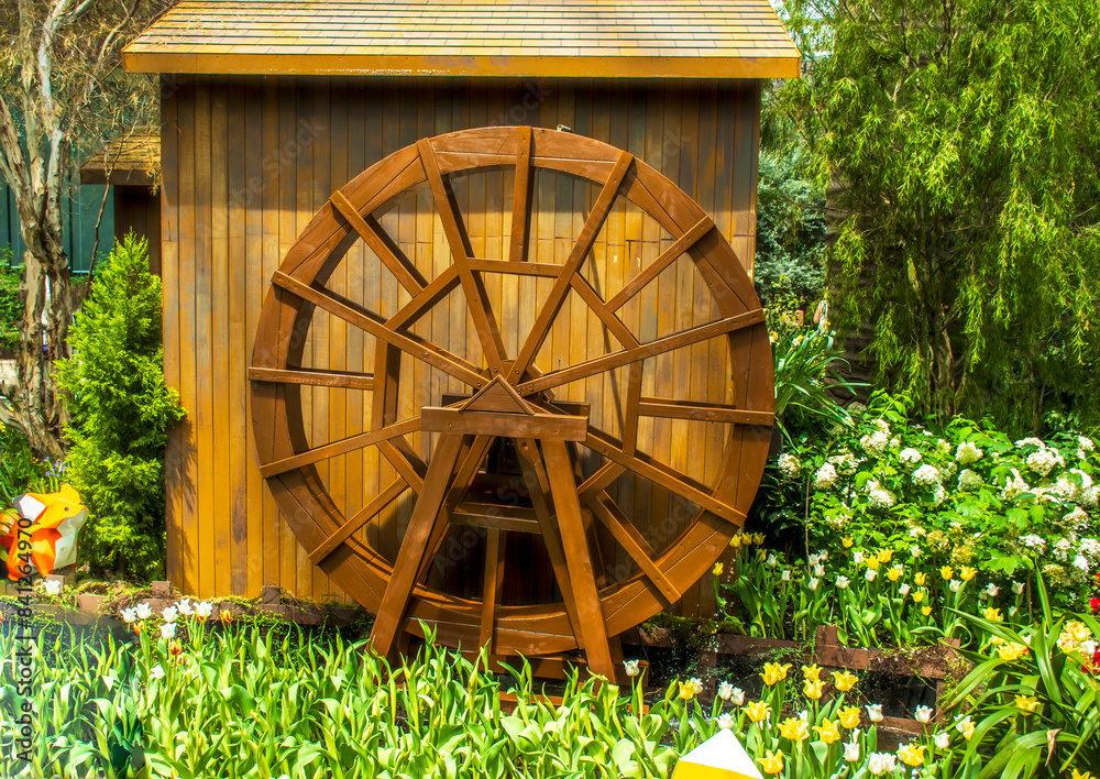 Wooden Water Wheel lifting the water in Garden Wooden Water Wheel lifting the water in Garden