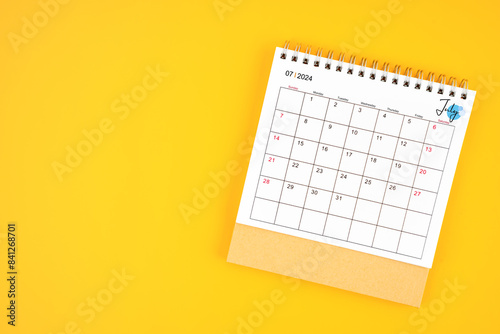 July 2024 desk calendar on yellow color background.