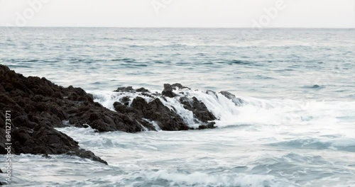 Ocean Waves Crashing on Rocky Coastline photo