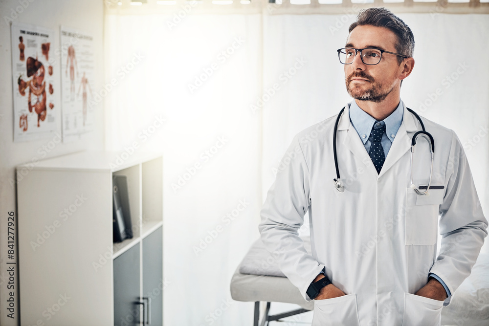 Doctor, thinking and mature man with confidence in hospital for healthcare, consult or planning. Lens flare, urology and physician with stethoscope for medical service, infertility treatment or trust Doctor, thinking and mature man with confidence in hospital for healthcare, consult or planning. Lens flare, urology and physician with stethoscope for medical service, infertility treatment or trust