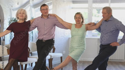 In dance studio students group of different ages performs Irish folk dance round dance in New Year Atmosphere. Modern hobby for active people.