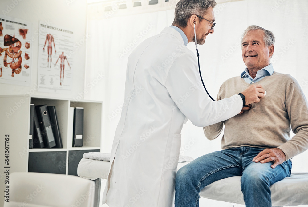Obraz premium Consultation, man and doctor in checkup with stethoscope, help and advice for healthcare in office. Clinic, senior patient and medical professional at desk with support, trust and heart health on bed