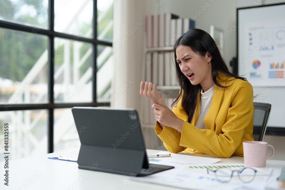 Beautiful Asian businesswoman suffering from shoulder and back pain, stress, headache after a hard day's work. The concept of office syndrome. Beautiful Asian businesswoman suffering from shoulder and back pain, stress, headache after a hard day's work. The concept of office syndrome.