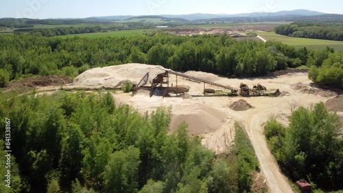 An Old Sand Mine Nestled in the Heart of a Lush Green Landscape Near the Town of Prudnik, Poland - Aerial Drone Shot photo